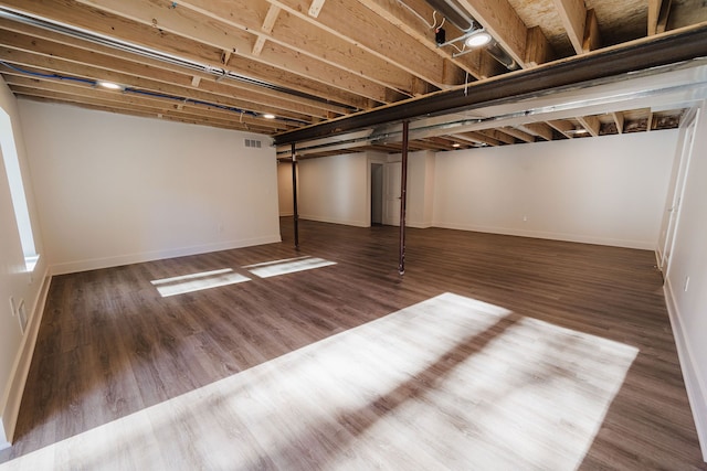 basement with dark wood-type flooring