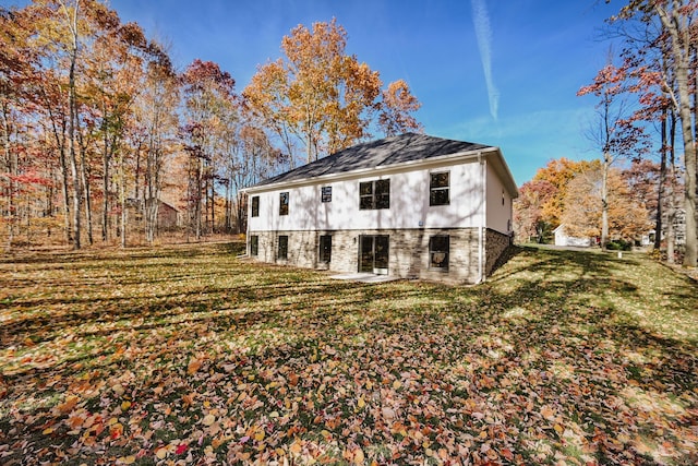 rear view of property featuring a yard