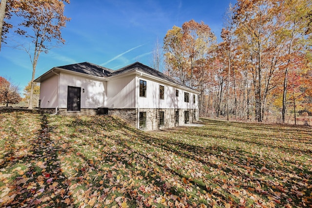 view of home's exterior with a lawn