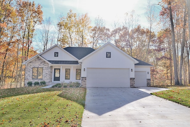 view of front of property with a front yard and a garage