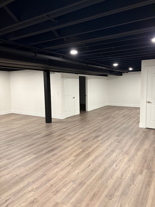 basement featuring hardwood / wood-style floors