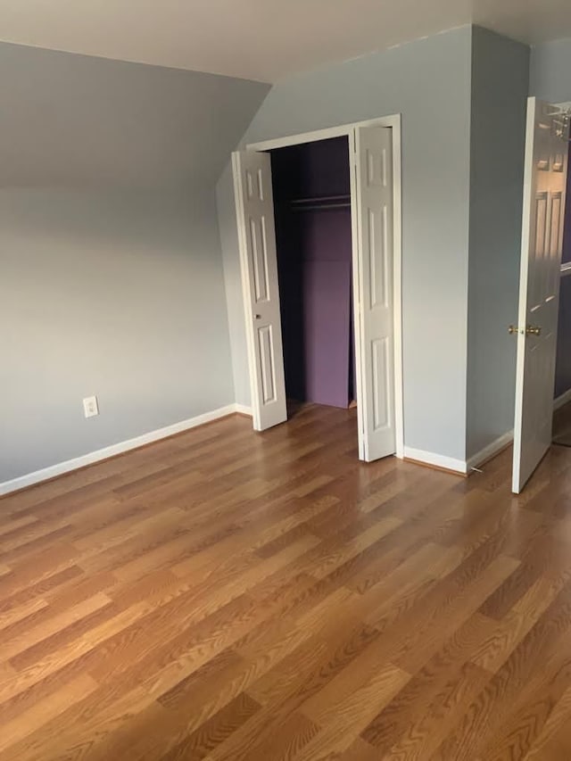 unfurnished bedroom featuring a closet and wood-type flooring