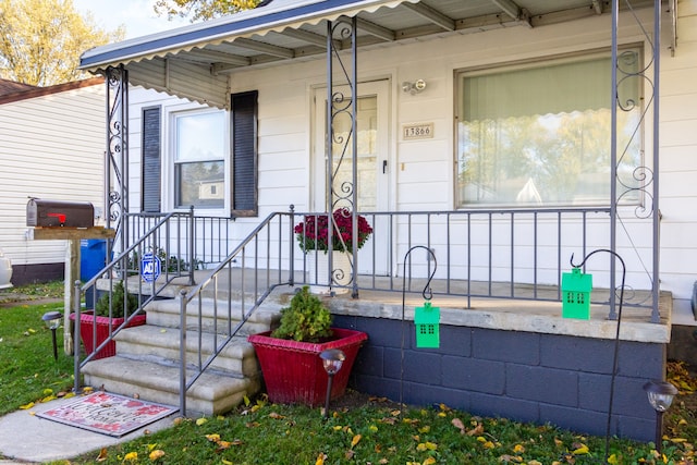 view of exterior entry with a porch