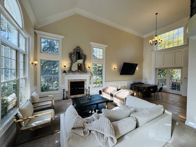 living room featuring high vaulted ceiling, a notable chandelier, and a wealth of natural light