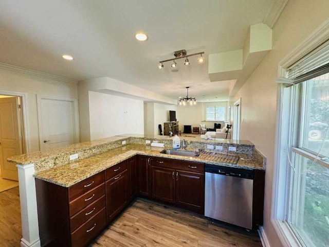 kitchen with light stone countertops, sink, an inviting chandelier, dishwasher, and light hardwood / wood-style floors