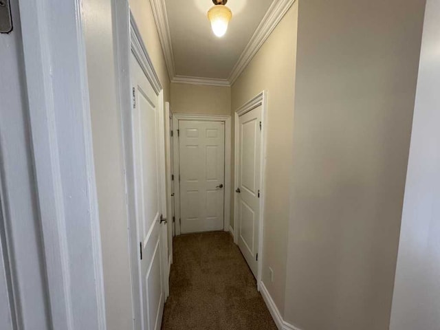 corridor featuring dark carpet and ornamental molding