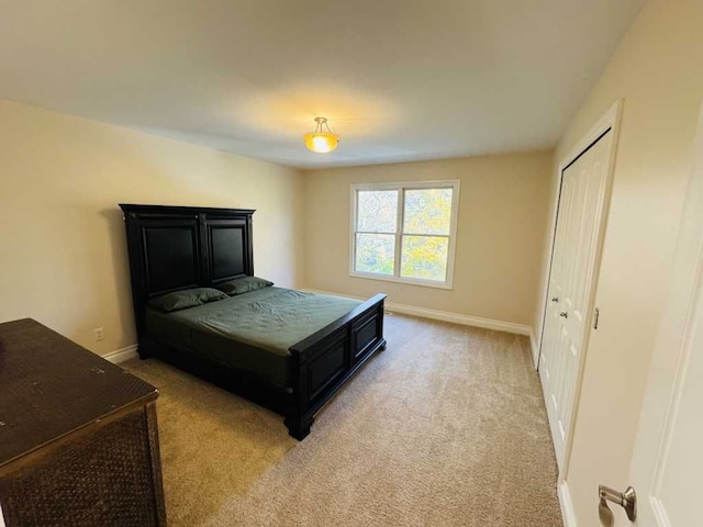 bedroom featuring light carpet and a closet