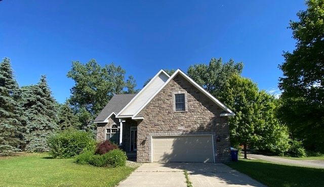 view of front of home featuring a garage and a front lawn