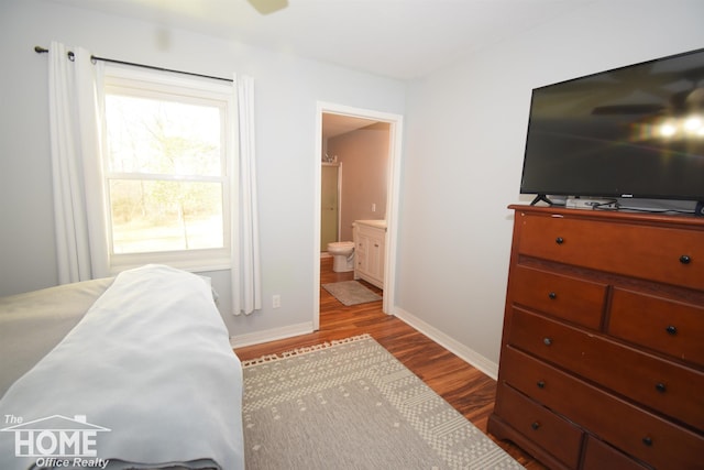 bedroom with light wood-type flooring and ensuite bathroom