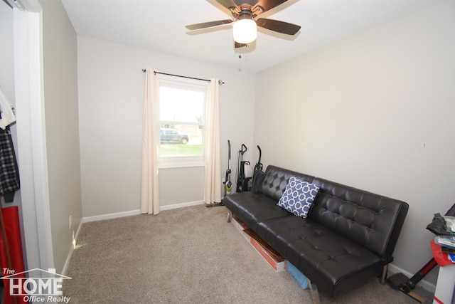 living area featuring ceiling fan and carpet