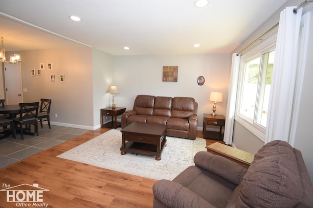 living room with an inviting chandelier and hardwood / wood-style flooring