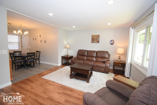 living room featuring wood-type flooring and a notable chandelier