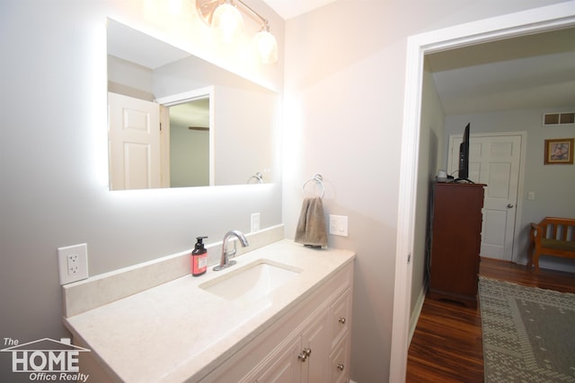 bathroom with hardwood / wood-style floors and vanity