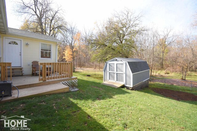 view of yard featuring a storage shed and a wooden deck