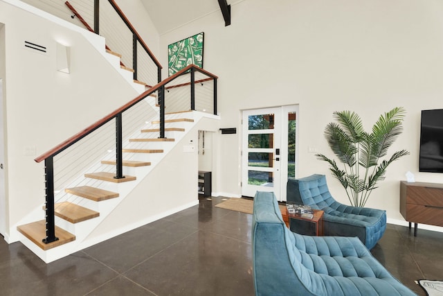 interior space with a high ceiling and concrete floors