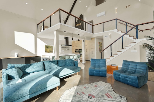 living room featuring concrete flooring and high vaulted ceiling