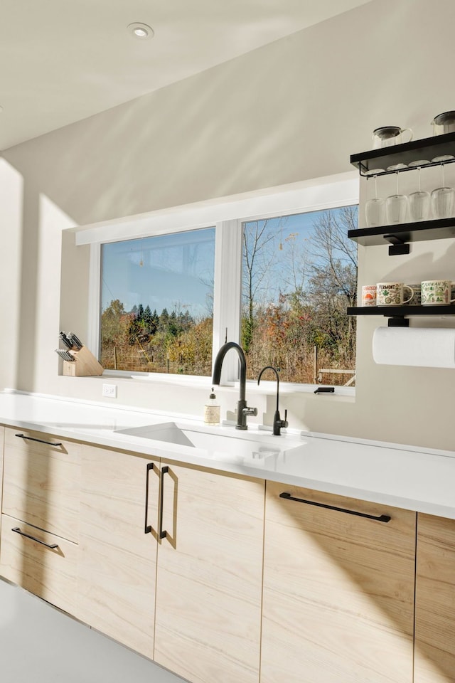 interior space with light brown cabinets and sink