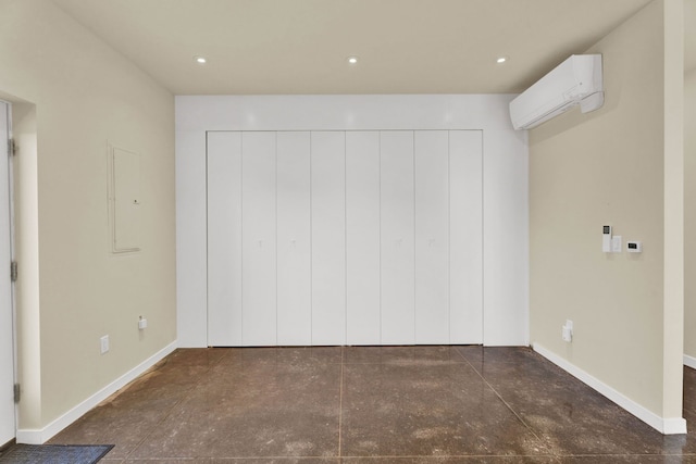 unfurnished bedroom featuring a wall unit AC and a closet