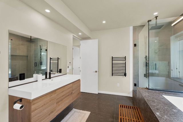 bathroom with tile patterned flooring, vanity, and walk in shower