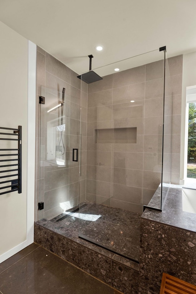 bathroom featuring an enclosed shower and radiator heating unit