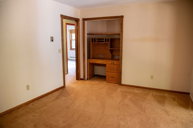 unfurnished office featuring light colored carpet and baseboard heating