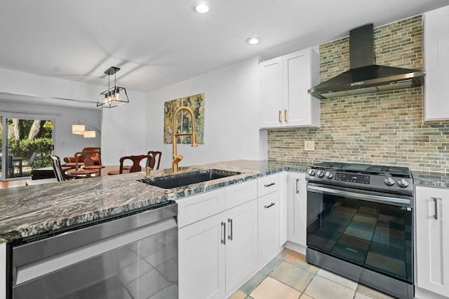 kitchen with white cabinetry, sink, wall chimney exhaust hood, stainless steel appliances, and backsplash