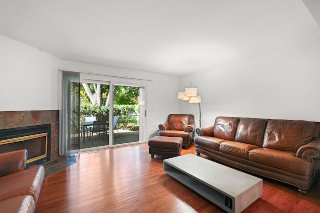 living room featuring a fireplace and dark hardwood / wood-style flooring