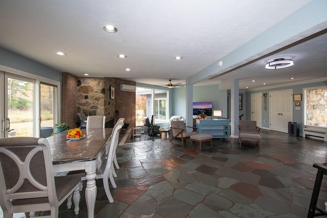 dining room featuring a wall mounted AC, radiator, ceiling fan, and crown molding