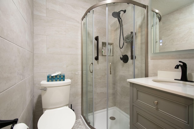 bathroom with vanity, toilet, and an enclosed shower