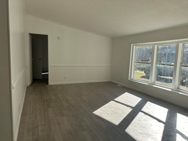 spare room with dark hardwood / wood-style flooring and ornamental molding