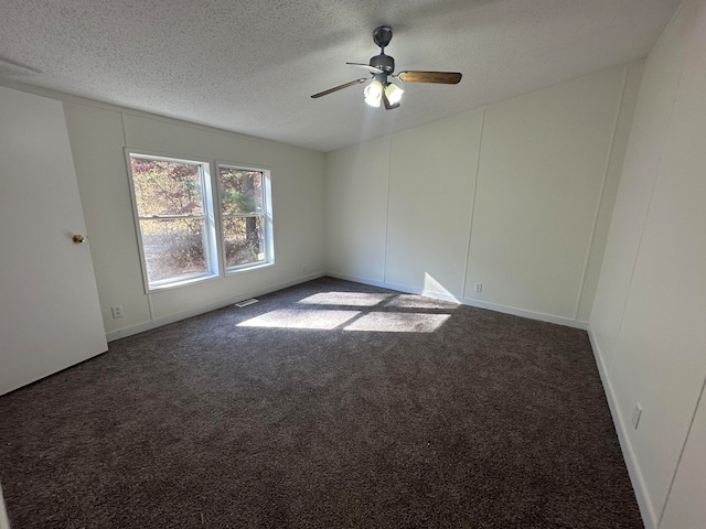 carpeted spare room featuring a textured ceiling and ceiling fan