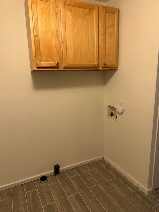 laundry room with cabinets, hookup for a washing machine, and dark hardwood / wood-style floors