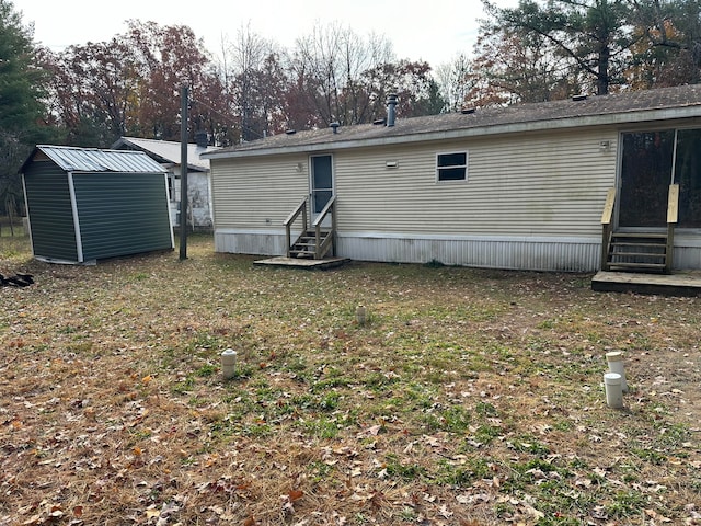 rear view of house with a storage shed