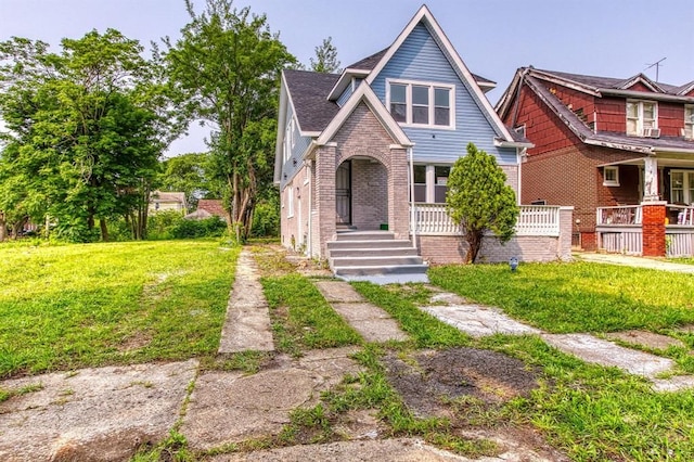 view of front of property with a front yard and a porch