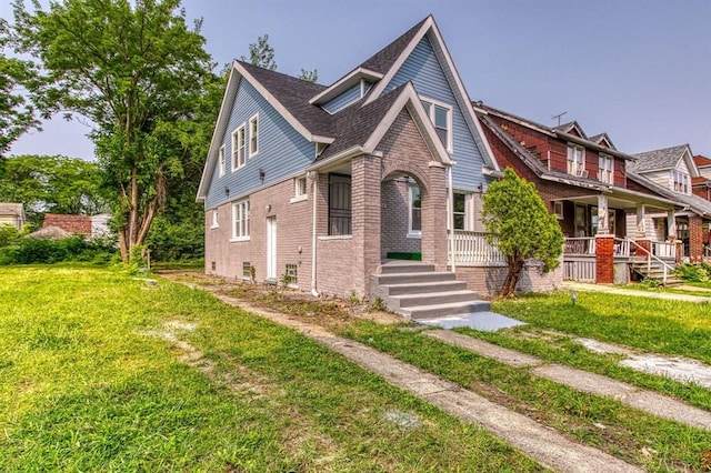 view of front facade featuring covered porch and a front yard