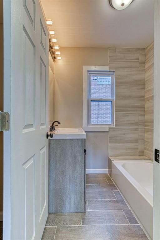 bathroom with vanity and a bath