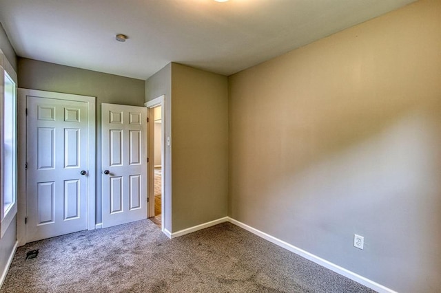 unfurnished bedroom featuring a closet and carpet floors