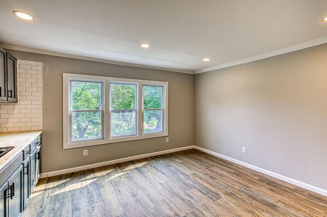 interior space with ornamental molding and light wood-type flooring