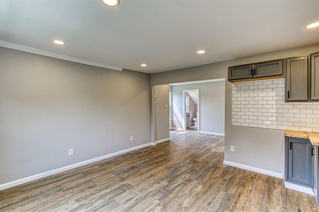 interior space featuring dark hardwood / wood-style flooring, backsplash, and butcher block counters