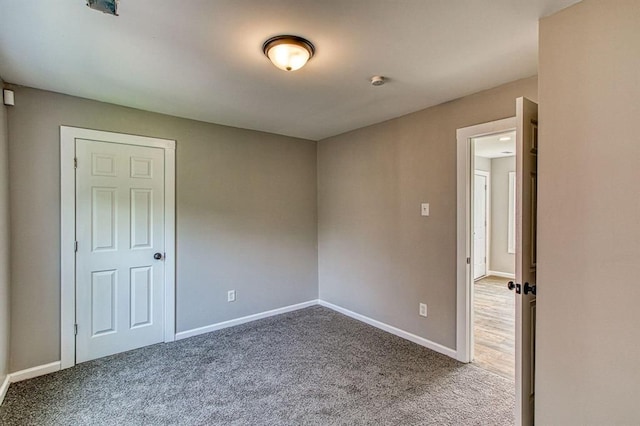 unfurnished room featuring carpet