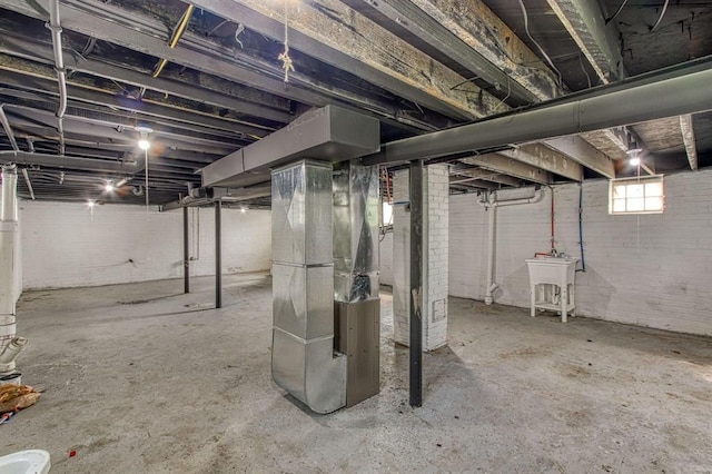 basement featuring sink and heating unit