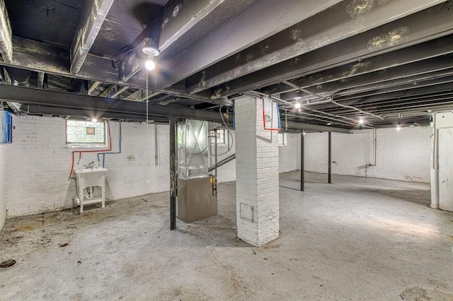 basement with heating unit and sink