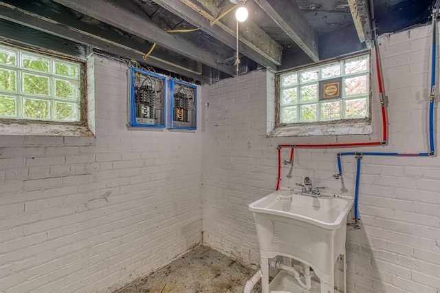 basement with sink and brick wall