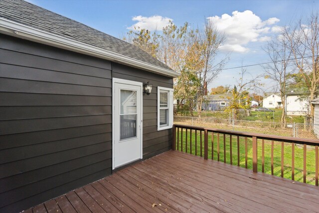 wooden deck featuring a lawn