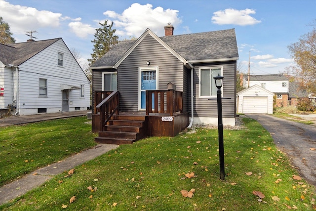 bungalow-style house featuring an outdoor structure, a front yard, and a garage