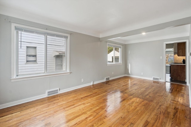 unfurnished room with light hardwood / wood-style floors