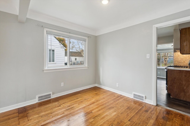 spare room with light hardwood / wood-style flooring