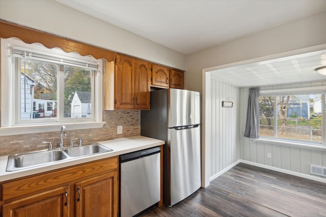 kitchen featuring decorative backsplash, sink, stainless steel appliances, and plenty of natural light