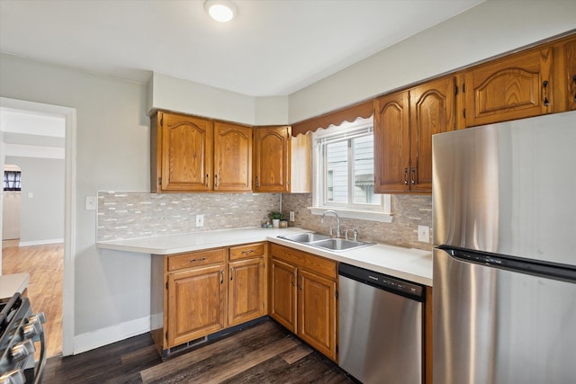 kitchen with tasteful backsplash, sink, dark hardwood / wood-style floors, and appliances with stainless steel finishes