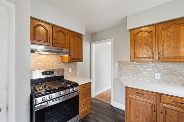 kitchen with tasteful backsplash, stainless steel range with gas cooktop, and dark hardwood / wood-style floors